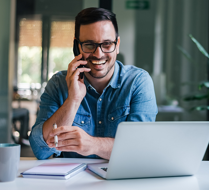 Man smiling while talking on the phone with San Antonio dental office