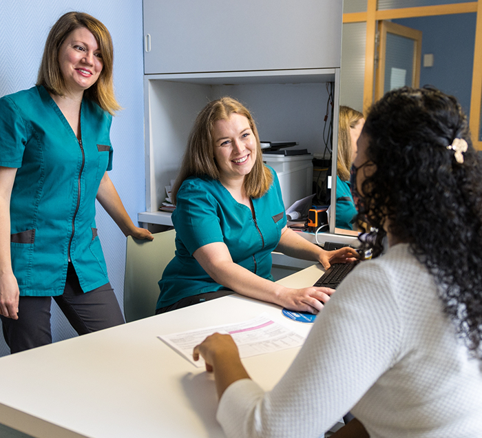 Two San Antonio dental team members smiling at a patient