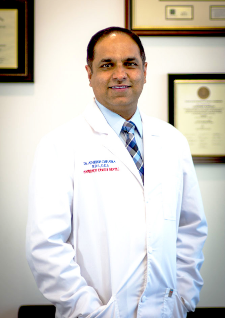 San Antonio dentist Doctor AJ smiling in a white lab coat