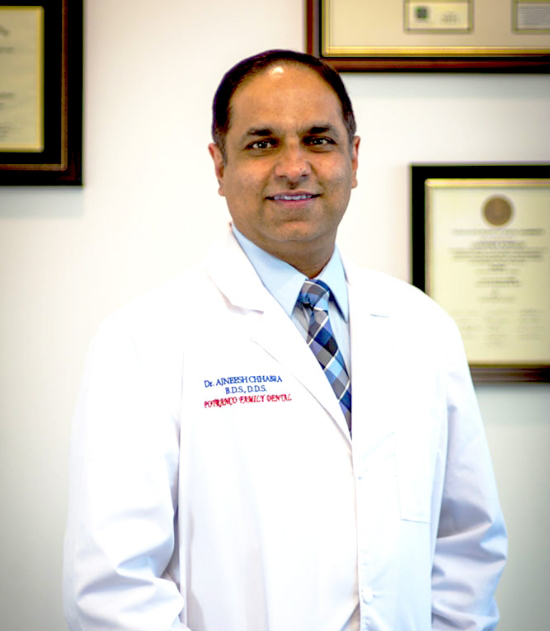 San Antonio dentist Doctor A J smiling in a white lab coat