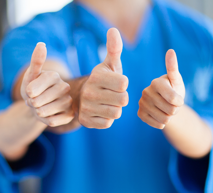 Three San Antonio dental team members giving thumbs up